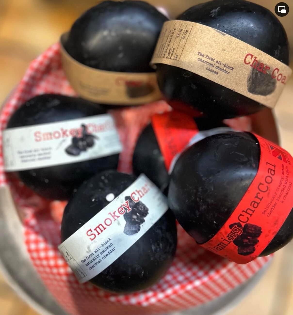 A number of black charcoal cheddar cheeses, including original flavour, chilli and smoked