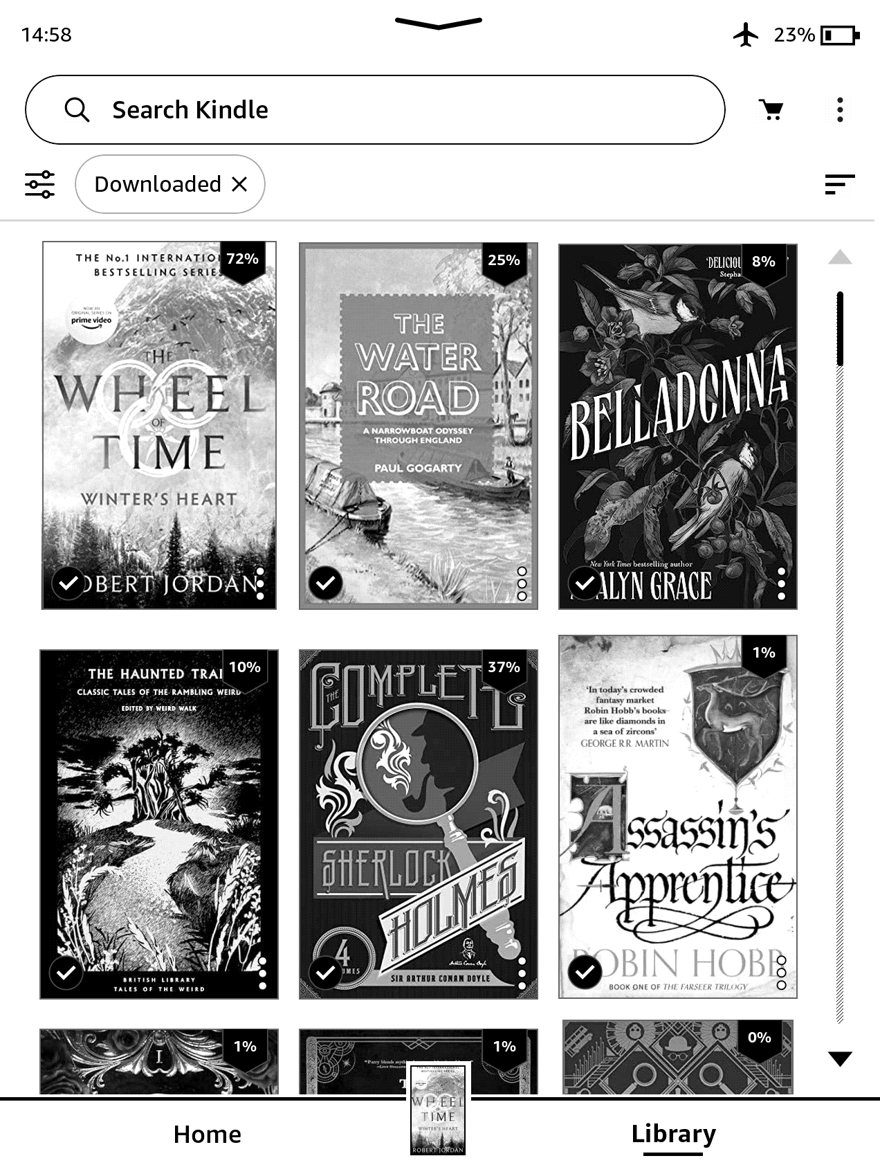 Screenshot of a Kindle Paperwhite, black & white screen, showing 6 book covers. On the top row are Wheel of Time Winter's Heart by Robert Jordan, The Water Road narrowboat book by Paul Gogarty and Belladonna by Adalyn Grace. Below are The Haunted Trail collection of weird fiction in the British Library Tales of the Weird series, a collected Complete Sherlock Holmes, and Assassin's Apprentice by Robin Hobb. Progress percentages for the books include 72% through the Wheel of Time book, 25% through the canals book, 8% through Belladonna (only recently started), and 37% through Sherlock Holmes (nearing the end of "Memoirs").